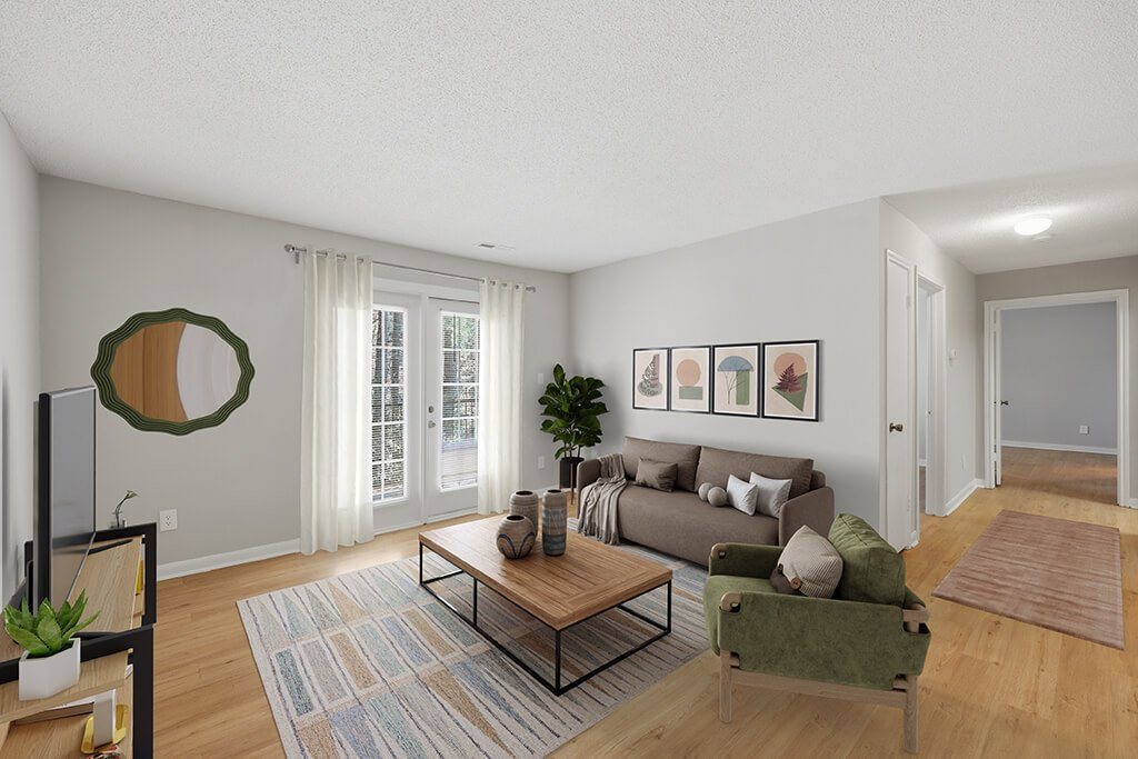 Living room with large window at Greens of Pine Glen in Durham NC
